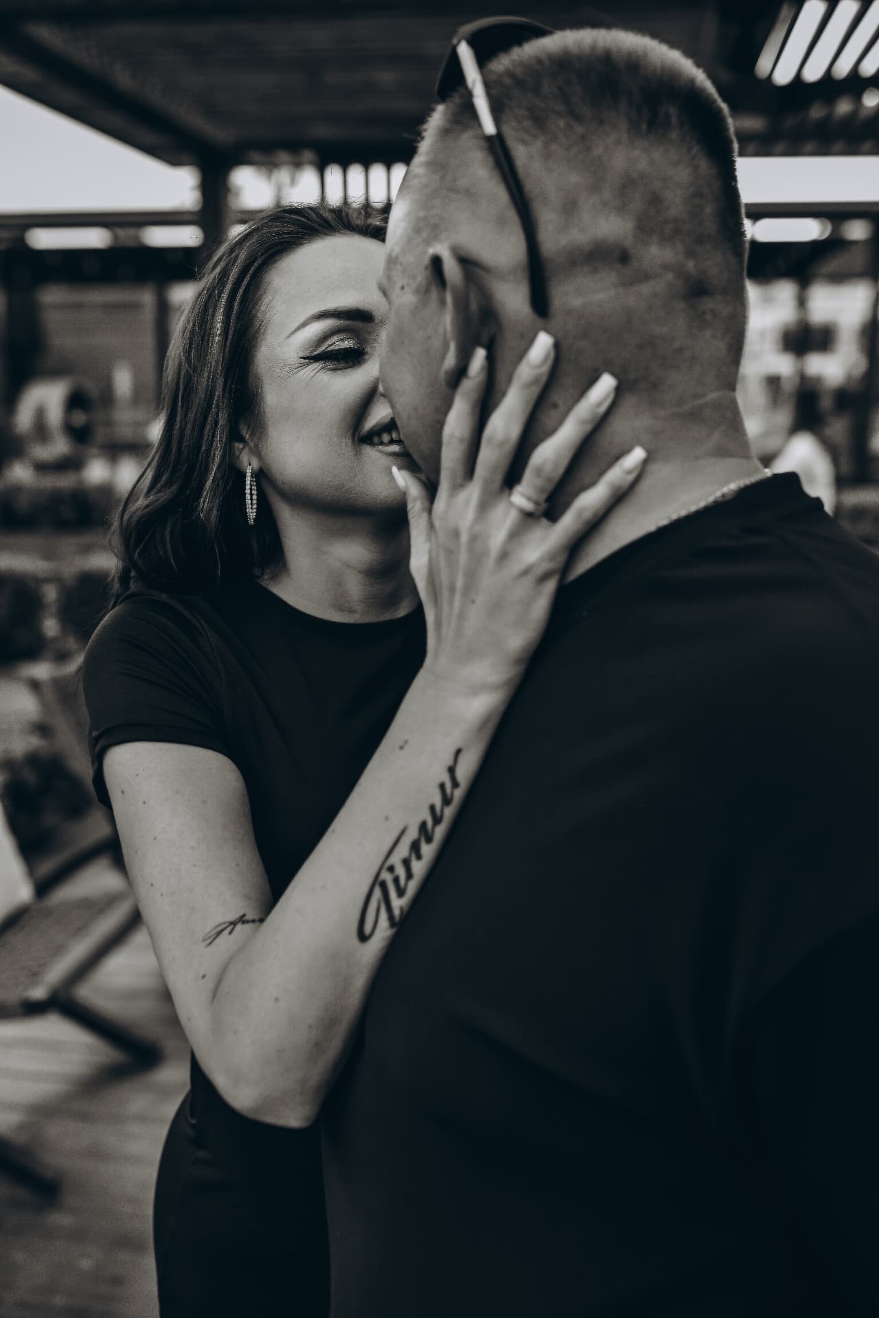 Black and white close-up of a woman laughing with her partner