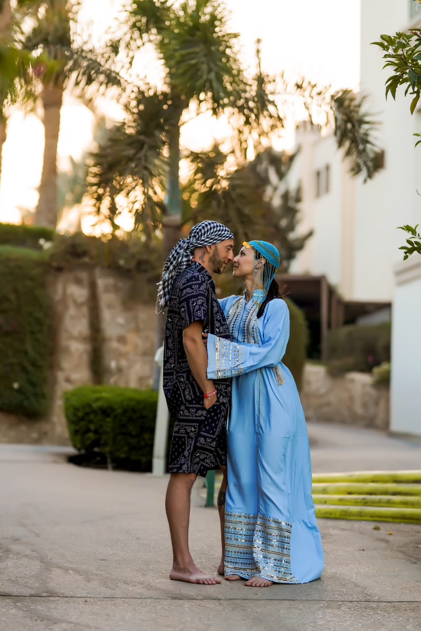 Couple in traditional Egyptian dress standing forehead to forehead