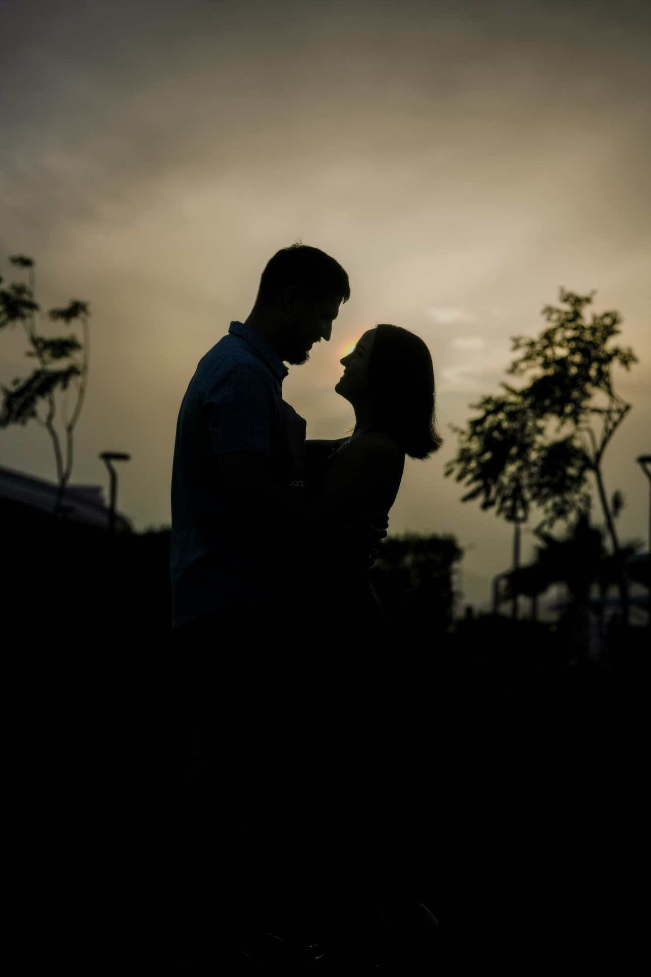 Silhouette of a couple facing each other at dusk